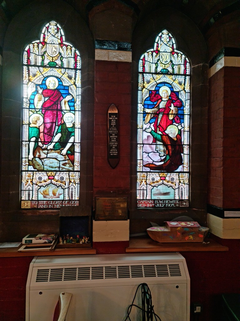 The stained glass window described: "Christ walking on the sea" is the scene in this window given in memory of Captain H. W. Hewitt.